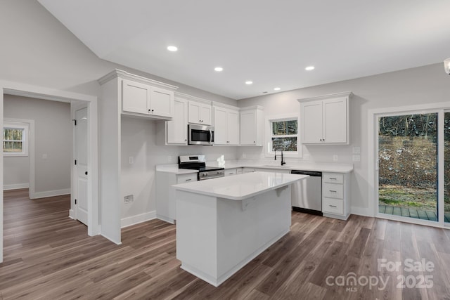 252 Big Lick Rd, Stanfield, NC 28163 - kitchen featuring white cabinets, stainless steel appliances, a sink, a center island, and baseboards