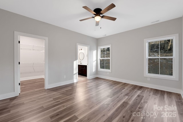 252 Big Lick Rd, Stanfield, NC 28163 - interior space featuring baseboards, a ceiling fan, wood finished floors, and visible vents