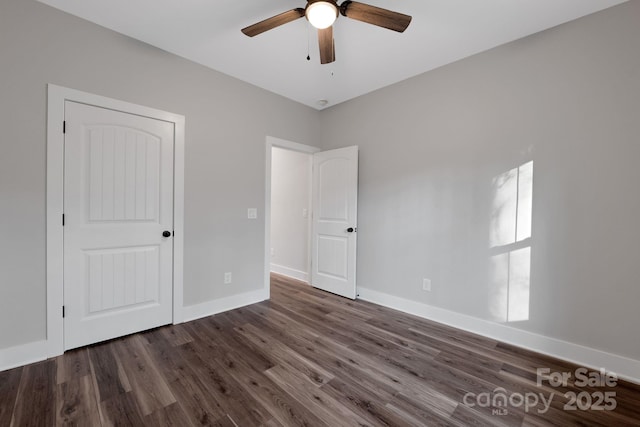 252 Big Lick Rd, Stanfield, NC 28163 - unfurnished bedroom featuring wood finished floors, a ceiling fan, and baseboards