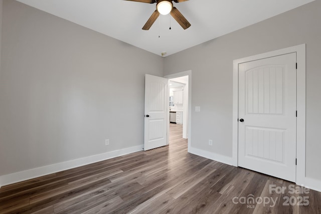 252 Big Lick Rd, Stanfield, NC 28163 - unfurnished bedroom with baseboards, wood finished floors, and ceiling fan