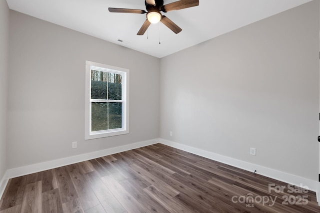 252 Big Lick Rd, Stanfield, NC 28163 - unfurnished room featuring dark wood-style floors, baseboards, a ceiling fan, and visible vents
