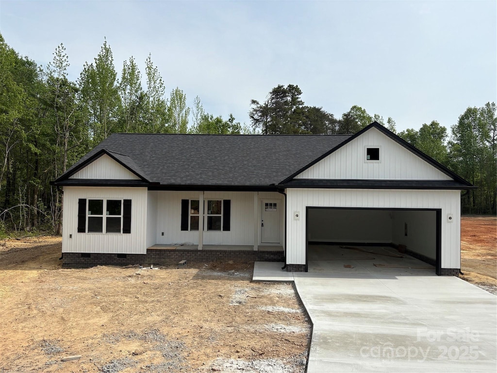 modern farmhouse style home featuring a porch, crawl space, concrete driveway, an attached garage, and a shingled roof