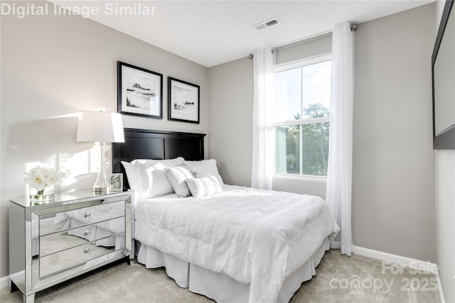 bedroom with visible vents, light colored carpet, and baseboards
