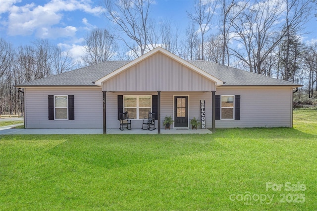 back of house with a lawn, a porch, and a shingled roof