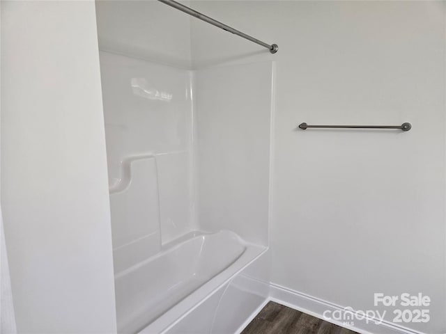 bathroom featuring baseboards and wood finished floors