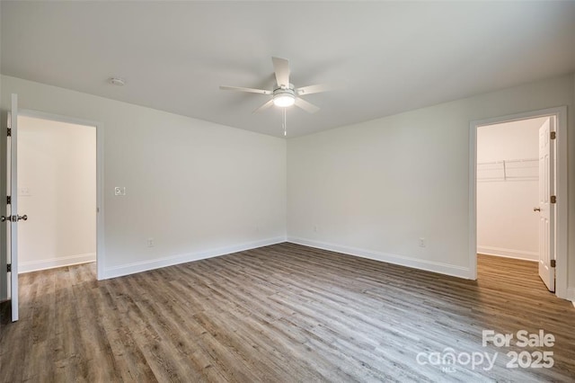 unfurnished room with ceiling fan, baseboards, and wood finished floors