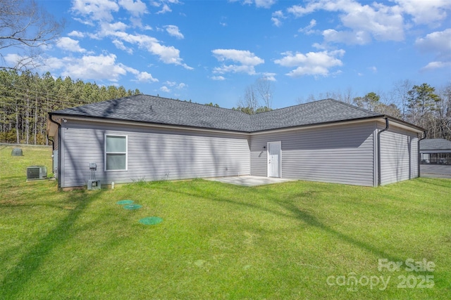 rear view of property with a yard, central AC, and a patio