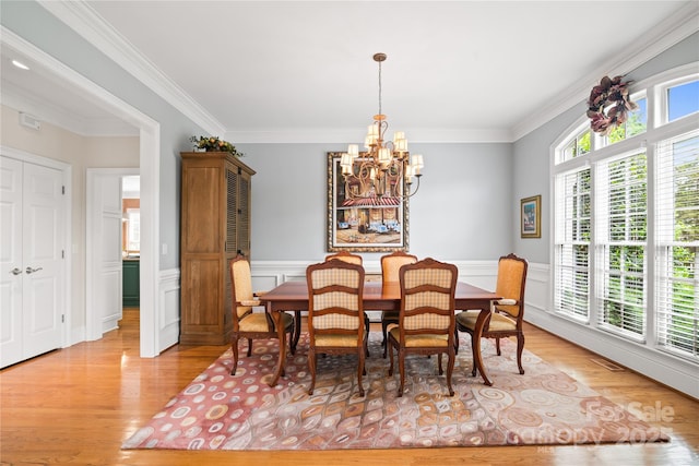 3420 Maryhurst Ln, Charlotte, NC 28226 - dining area with a chandelier, light wood-style floors, wainscoting, and crown molding
