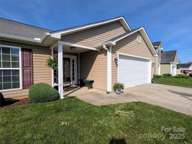 view of front of house with an attached garage, concrete driveway, and a front lawn