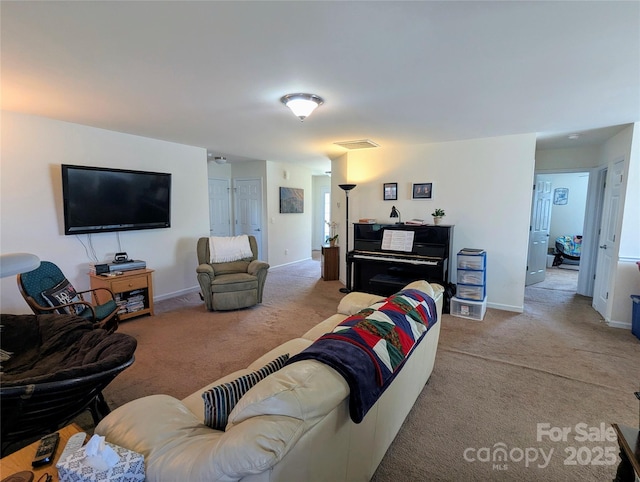 carpeted living area featuring baseboards and visible vents