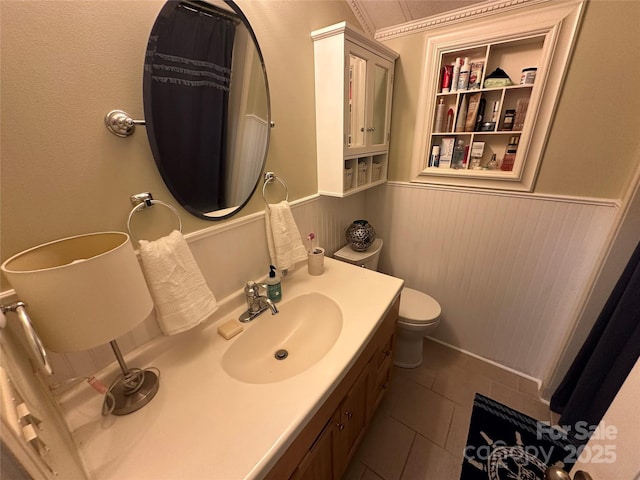 127 Hummingbird Cir, New London, NC 28127 - bathroom with toilet, vanity, built in features, tile patterned flooring, and wainscoting