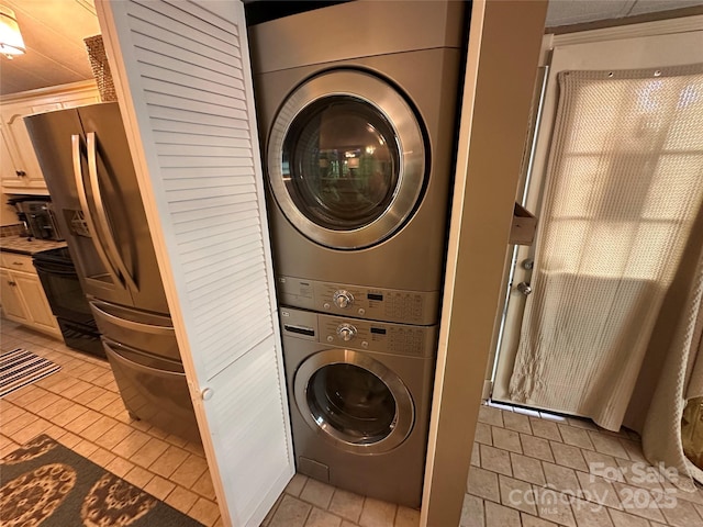 127 Hummingbird Cir, New London, NC 28127 - laundry room with laundry area, stacked washing maching and dryer, and light tile patterned floors