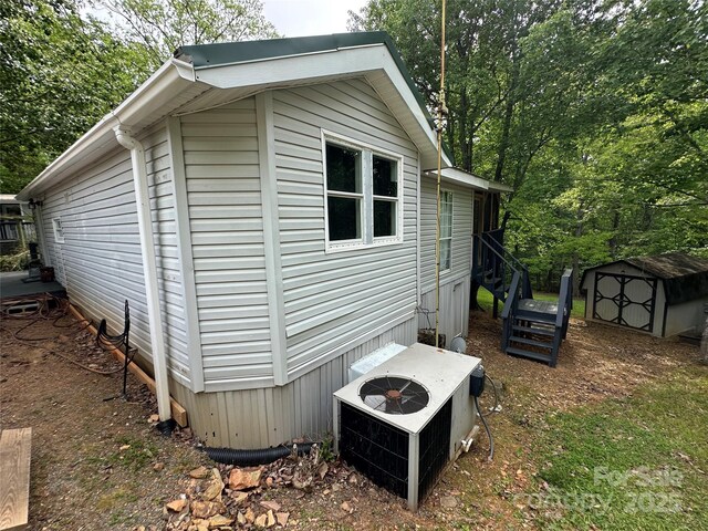 127 Hummingbird Cir, New London, NC 28127 - view of home's exterior featuring central AC unit, an outdoor structure, and a shed