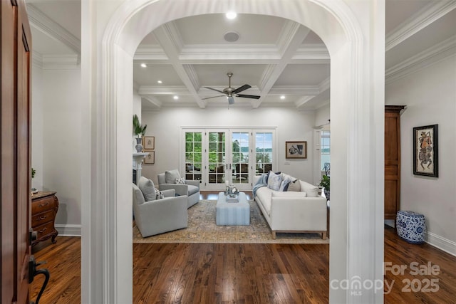 living room featuring arched walkways, ceiling fan, french doors, and dark wood finished floors