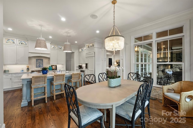 dining room with recessed lighting, ornamental molding, dark wood finished floors, and a chandelier