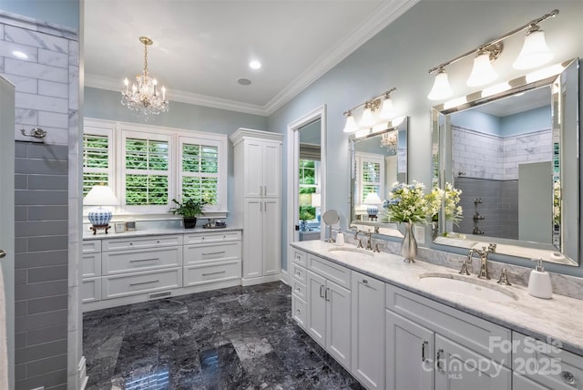 bathroom featuring an inviting chandelier, a sink, marble finish floor, and a wealth of natural light