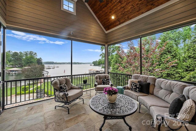 sunroom featuring an outdoor living space and a water view