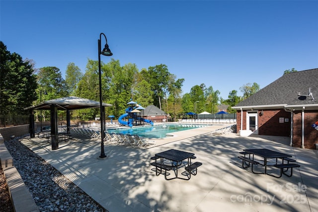 6005 Abergele Ln, Matthews, NC 28104 - community pool featuring fence, a gazebo, a water slide, a playground, and a patio