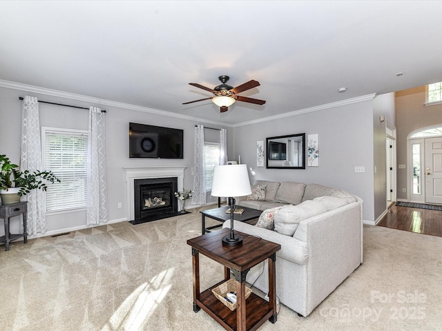 6005 Abergele Ln, Matthews, NC 28104 - carpeted living room with baseboards, a fireplace with flush hearth, ornamental molding, and ceiling fan