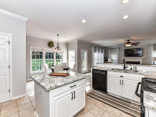 6005 Abergele Ln, Matthews, NC 28104 - kitchen featuring ornamental molding, a kitchen island, a sink, light tile patterned floors, and black appliances