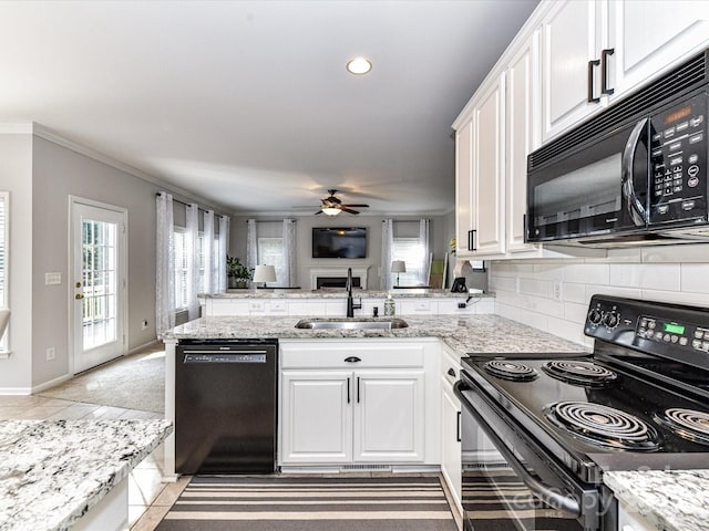 6005 Abergele Ln, Matthews, NC 28104 - kitchen with a sink, black appliances, a peninsula, and white cabinetry