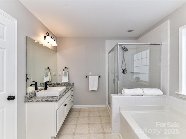6005 Abergele Ln, Matthews, NC 28104 - bathroom featuring a sink, baseboards, a stall shower, and a bath