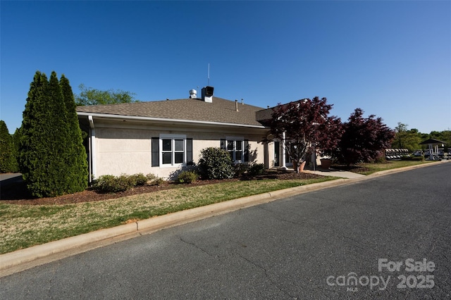 6005 Abergele Ln, Matthews, NC 28104 - view of front of home featuring stucco siding and a chimney