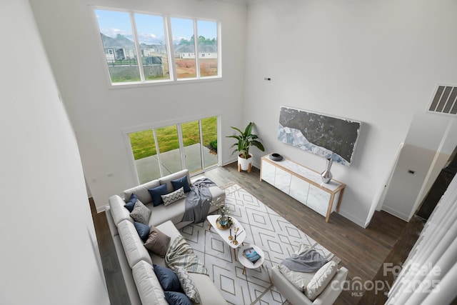 6712 Cove Ln, Sherrills Ford, NC 28673 - living room featuring wood finished floors, baseboards, healthy amount of natural light, and a towering ceiling