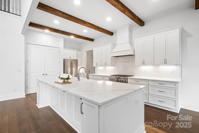 6712 Cove Ln, Sherrills Ford, NC 28673 - kitchen featuring premium range hood, stainless steel appliances, baseboards, tasteful backsplash, and white cabinetry