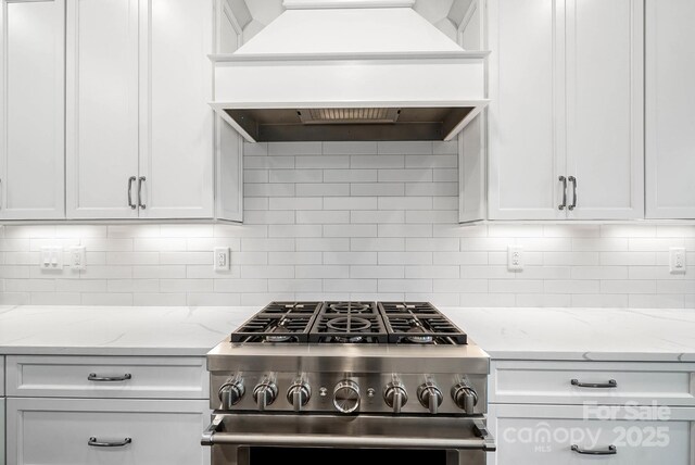 6712 Cove Ln, Sherrills Ford, NC 28673 - kitchen featuring stainless steel range with gas cooktop, white cabinets, and decorative backsplash