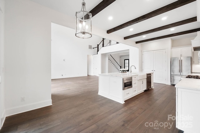 6712 Cove Ln, Sherrills Ford, NC 28673 - kitchen featuring stainless steel appliances, light countertops, white cabinets, dark wood finished floors, and a kitchen island with sink