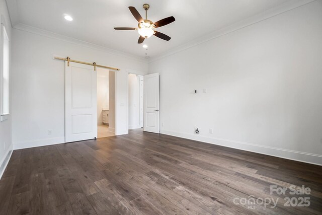 6712 Cove Ln, Sherrills Ford, NC 28673 - unfurnished bedroom featuring a barn door, wood finished floors, ornamental molding, baseboards, and connected bathroom