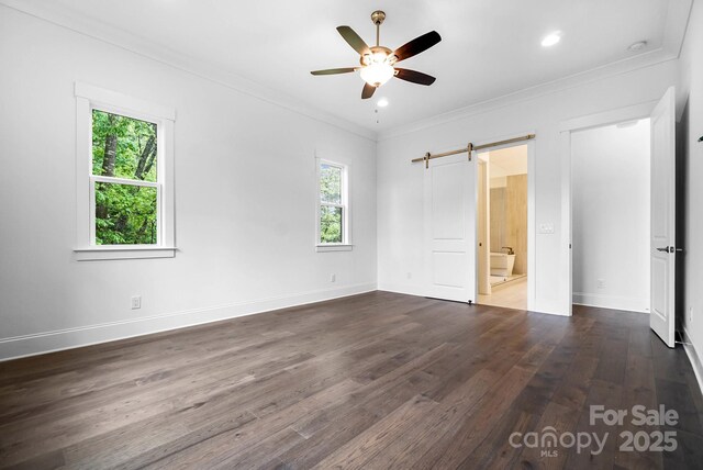 6712 Cove Ln, Sherrills Ford, NC 28673 - unfurnished bedroom with a barn door, dark wood-style flooring, ornamental molding, baseboards, and ensuite bath