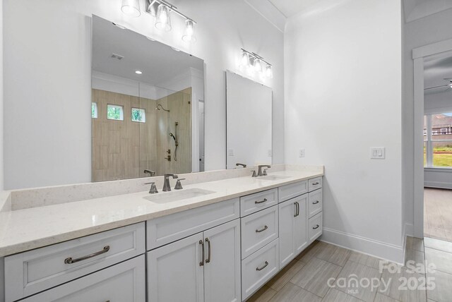 6712 Cove Ln, Sherrills Ford, NC 28673 - full bath with double vanity, a tile shower, healthy amount of natural light, and baseboards