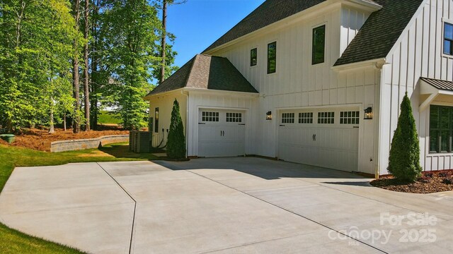 6712 Cove Ln, Sherrills Ford, NC 28673 - view of property exterior featuring roof with shingles, board and batten siding, a garage, and concrete driveway
