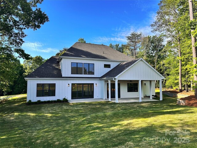 6712 Cove Ln, Sherrills Ford, NC 28673 - back of property featuring ceiling fan, a patio, a lawn, and a shingled roof