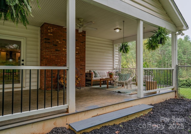 deck featuring an outdoor hangout area, covered porch, and ceiling fan