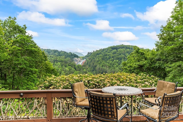 300 Falls View Dr, Lake Toxaway, NC 28774 - deck featuring outdoor dining space and a forest view