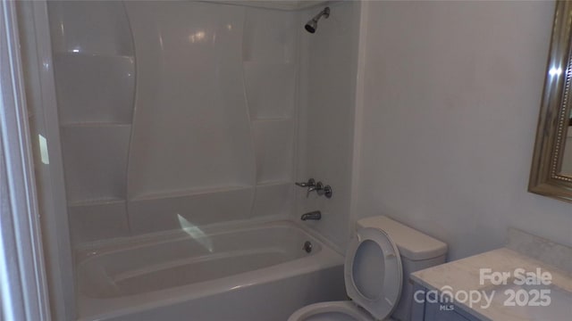 bathroom featuring toilet, shower / bathtub combination, and vanity