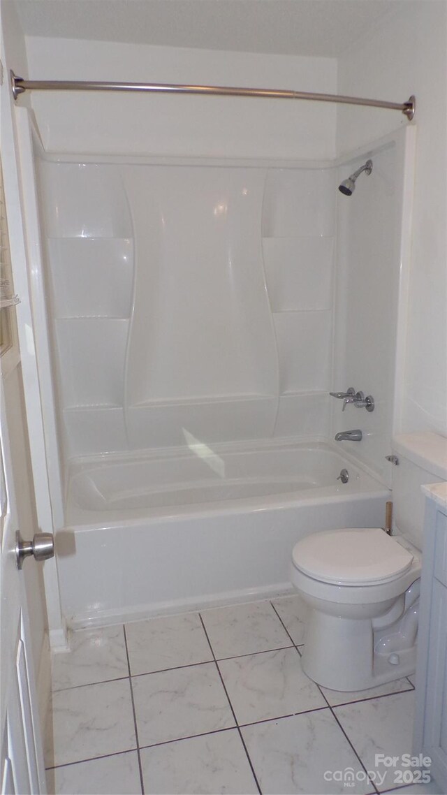 full bath with marble finish floor, toilet, vanity, and bathing tub / shower combination