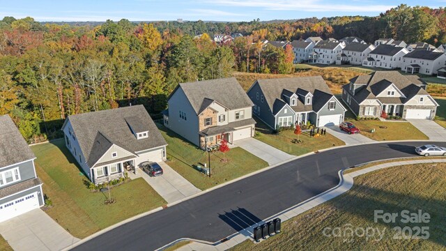 bird's eye view with a residential view and a wooded view