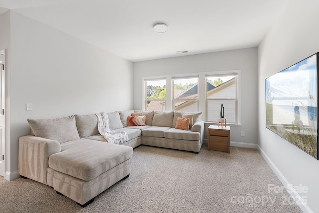 living area featuring visible vents, carpet floors, and baseboards