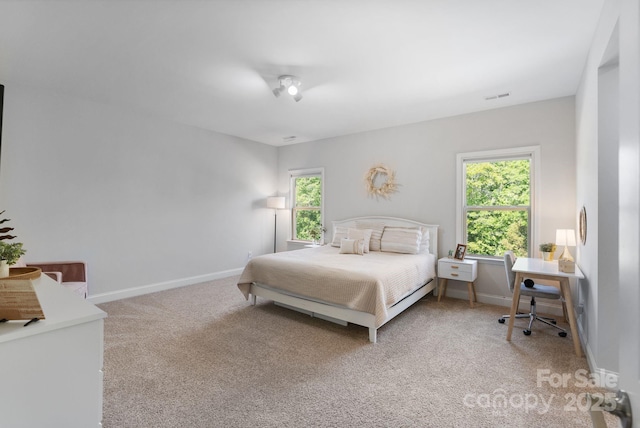 bedroom featuring baseboards, visible vents, multiple windows, and carpet flooring