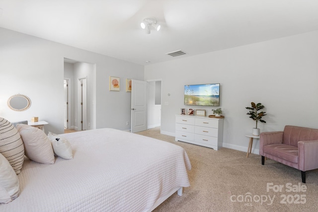 bedroom with visible vents, light carpet, and baseboards