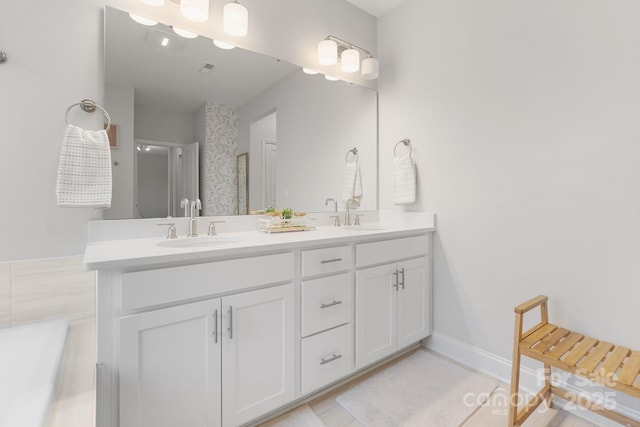 bathroom with double vanity and a sink