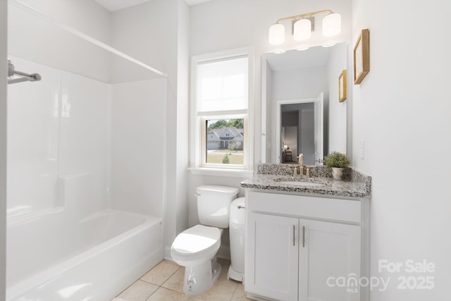 bathroom with vanity, toilet, tile patterned flooring, and bathing tub / shower combination