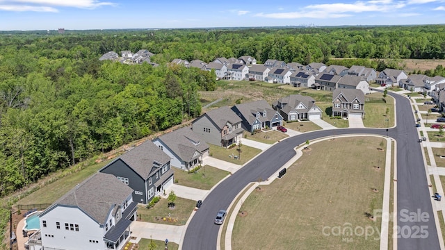 birds eye view of property with a residential view and a forest view