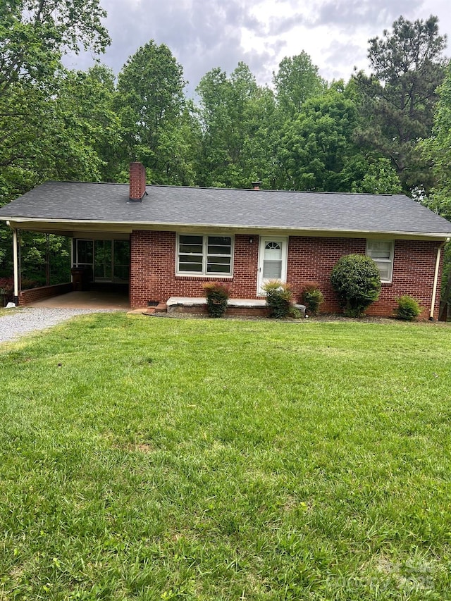 755 Victory Grove Church Rd, Lincolnton, NC 28092 - ranch-style home with gravel driveway, brick siding, a chimney, an attached carport, and a front lawn