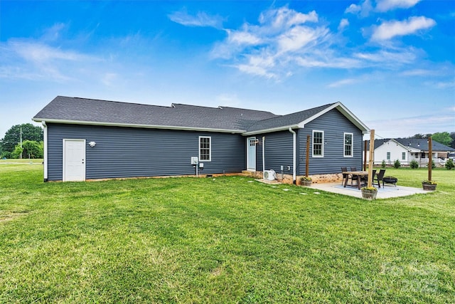 back of house with a lawn and a patio area