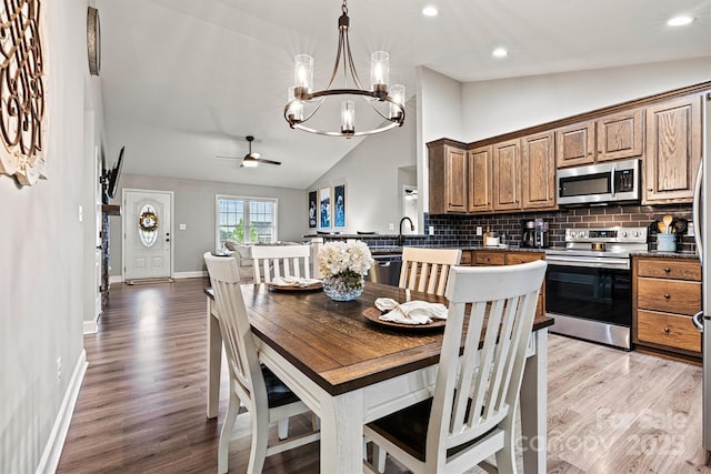 3615 Kimber Ln, Sherrills Ford, NC 28673 - dining space with recessed lighting, ceiling fan with notable chandelier, lofted ceiling, and light wood-type flooring